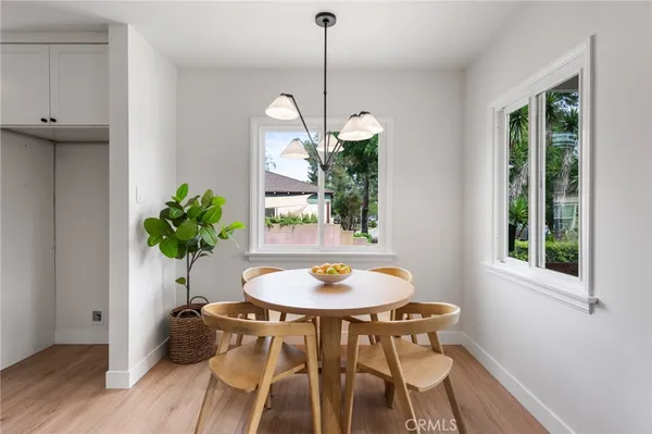 a kitchen with white cabinets white stainless steel appliances and sink
