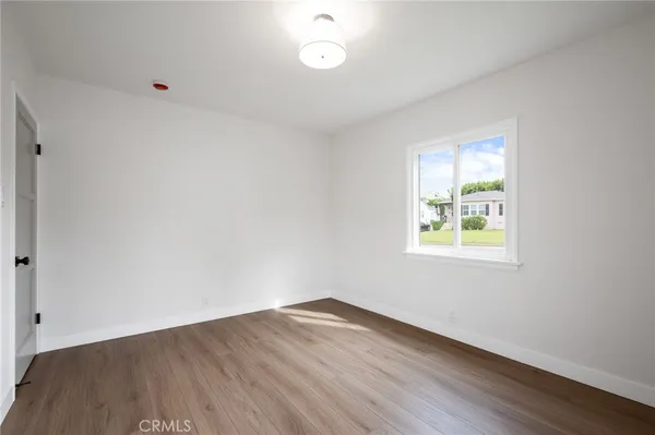 a view of a workspace room with wooden floor and dining table