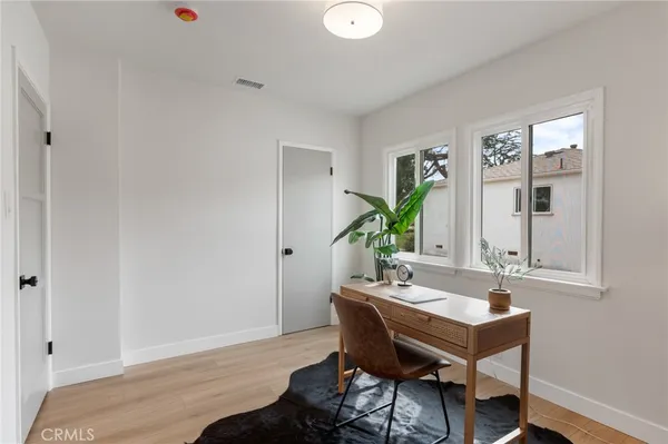 a room with wooden floor and glass door