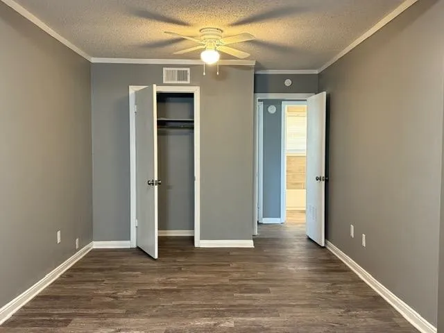 an empty room with wooden floor and door