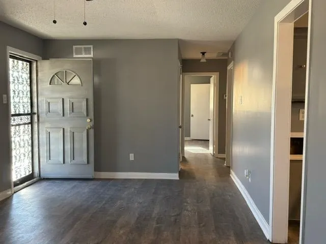 a view of a hallway with wooden floor