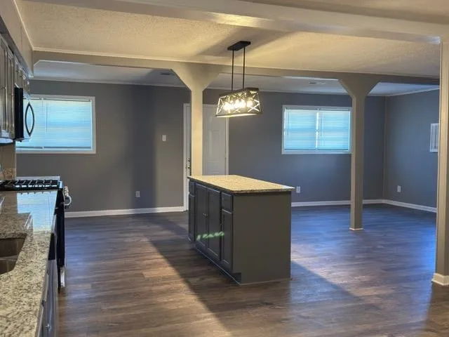 a kitchen with wooden floor and window