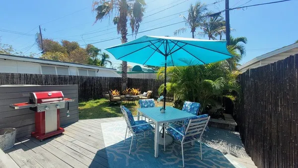 a view of a chairs and table in patio