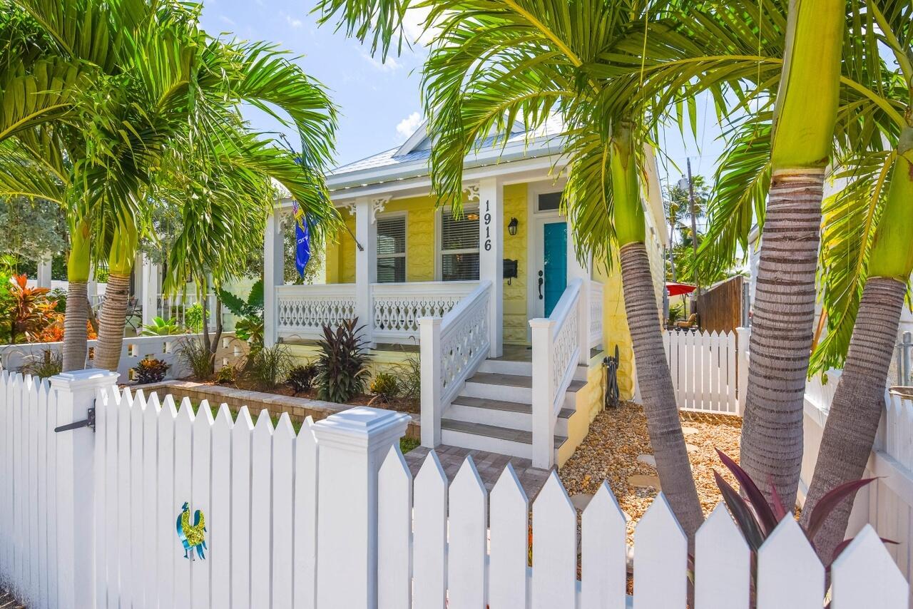 1916 Staples Avenue Key West, FL 33040 - Photo 3 of 18 a view of a house with large tree and wooden fence