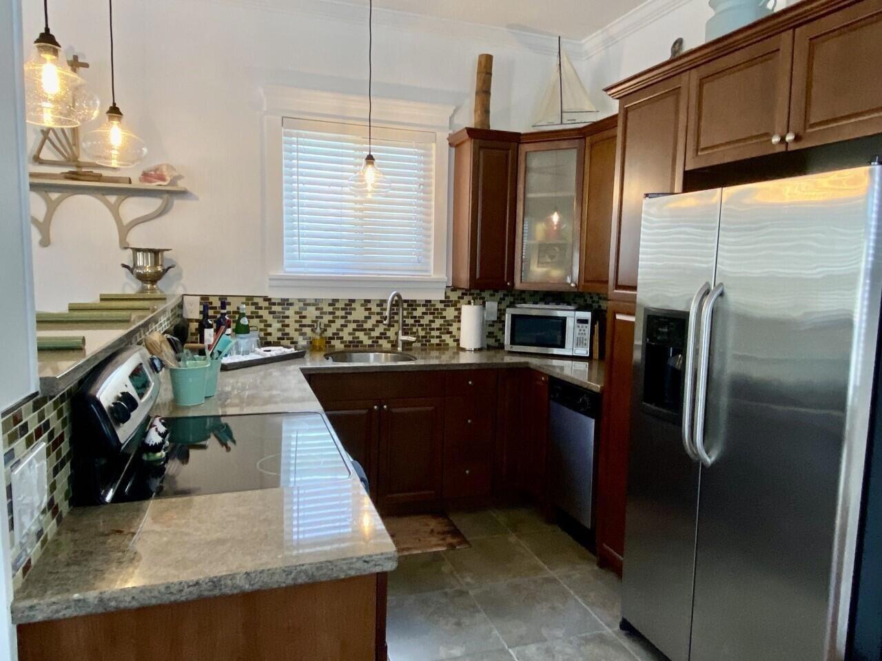 1916 Staples Avenue Key West, FL 33040 - Photo 8 of 18 a kitchen with stainless steel appliances granite countertop a sink stove and refrigerator