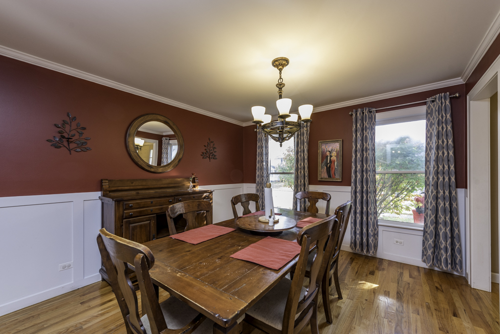 3482 Ellis Avenue Gurnee, IL 60031 - Photo 15 of 46 a view of a dining room with furniture a chandelier and wooden floor