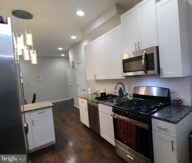 a kitchen with a sink stove and microwave