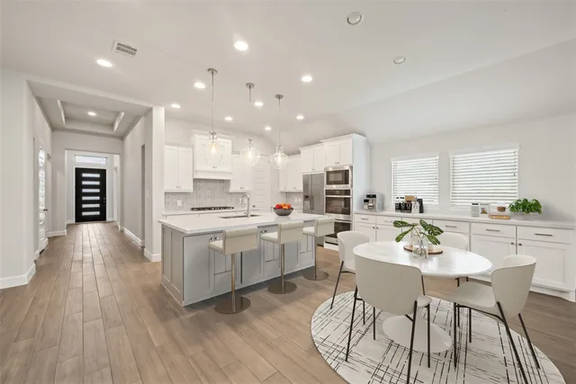 a living room with fireplace furniture and wooden floor