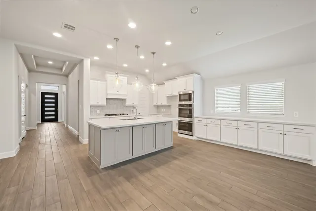 a spacious bathroom with a granite countertop sink a toilet and a mirror