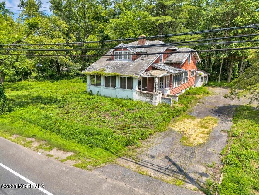 465 Lakewood Farmingdale Road Howell, NJ 07731 - Photo 6 of 19 a aerial view of a house with a yard and potted plants