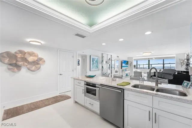 a kitchen with stainless steel appliances granite countertop a sink and a stove