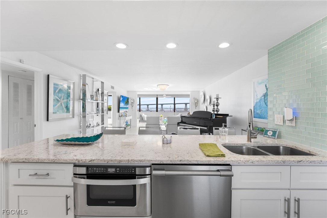 15010 Punta Rassa Road, Unit 106 Fort Myers, FL 33908 - Photo 14 of 36 a kitchen with a stove and a white cabinets