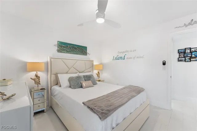 a bedroom with a bed and a wall painting