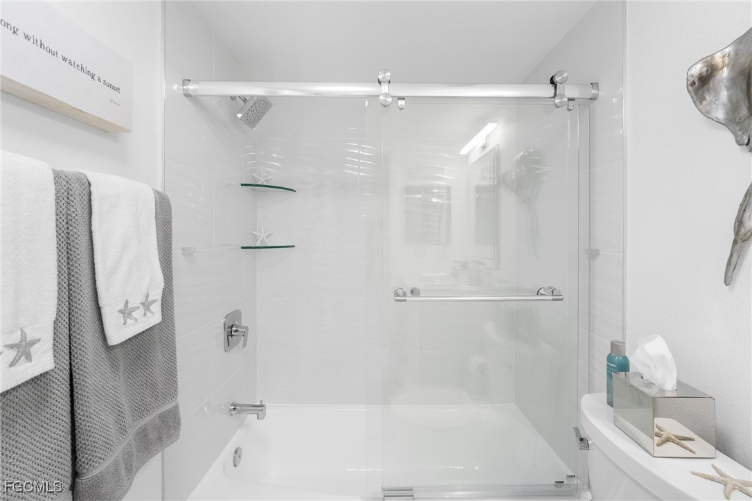 15010 Punta Rassa Road, Unit 106 Fort Myers, FL 33908 - Photo 25 of 36 a bathroom with a bathtub and a shower