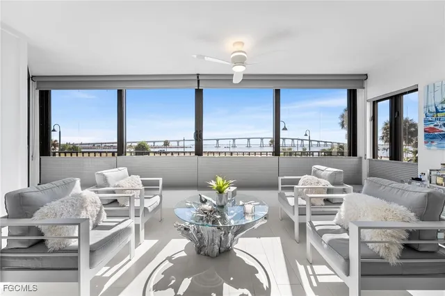 a living room with furniture and a floor to ceiling window