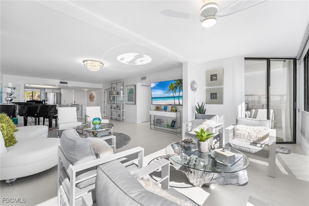 15010 Punta Rassa Road, Unit 106 Fort Myers, FL 33908 - Photo 5 of 36 a living room with furniture and wooden floor