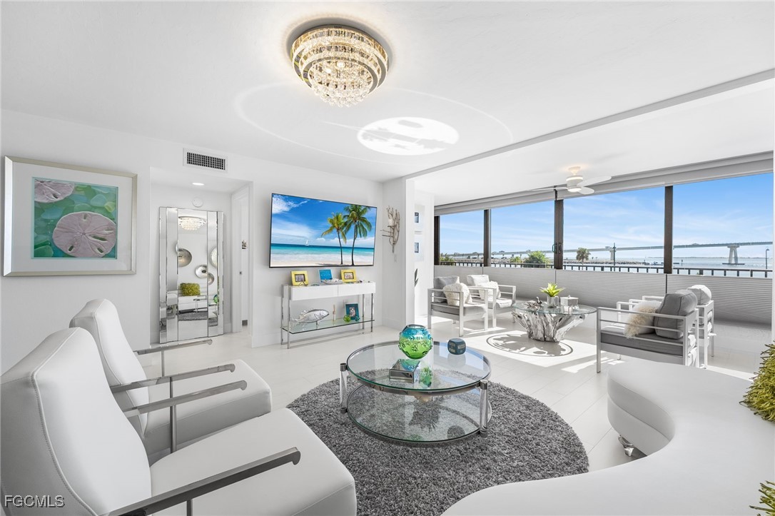 15010 Punta Rassa Road, Unit 106 Fort Myers, FL 33908 - Photo 6 of 36 a living room with furniture and a large window