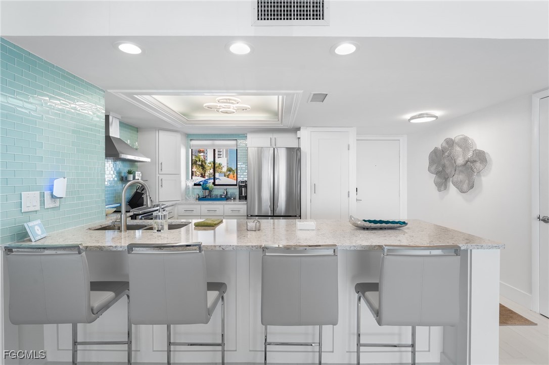 15010 Punta Rassa Road, Unit 106 Fort Myers, FL 33908 - Photo 9 of 36 a room with stainless steel appliances kitchen island granite countertop a sink and cabinets