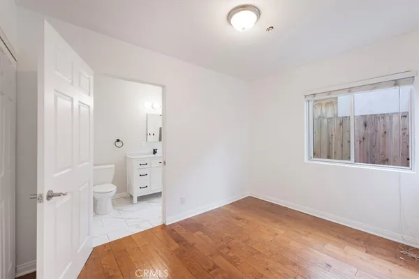 a bedroom with a bed and a view of bathroom