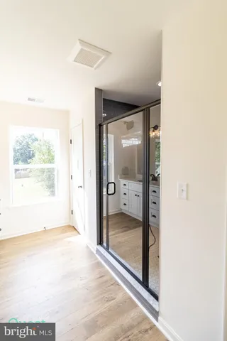 a view of a closet with racks on the wall