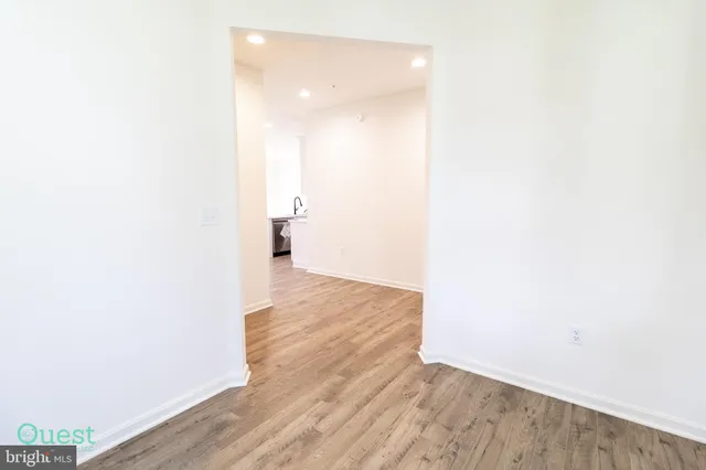 a kitchen with kitchen island granite countertop a sink and a stove top oven