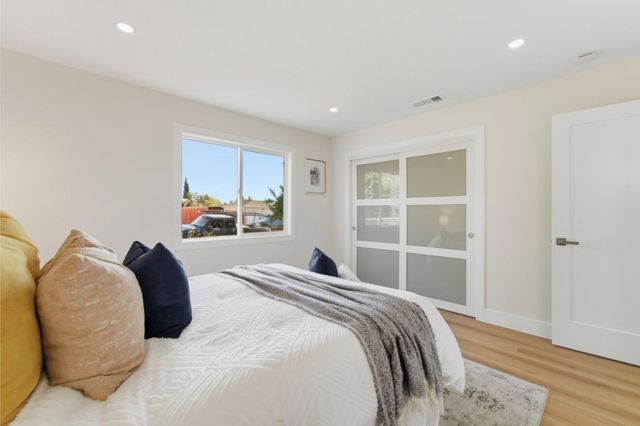 a bedroom with a large bed and a window