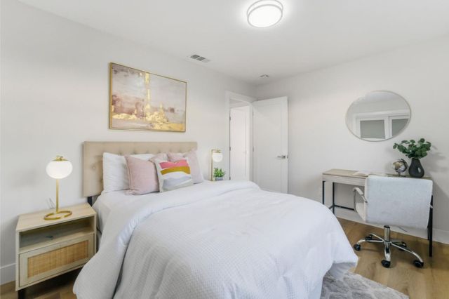 a bedroom with a bed and a desk