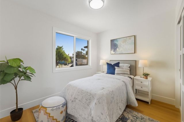 a bedroom with a bed and a plant