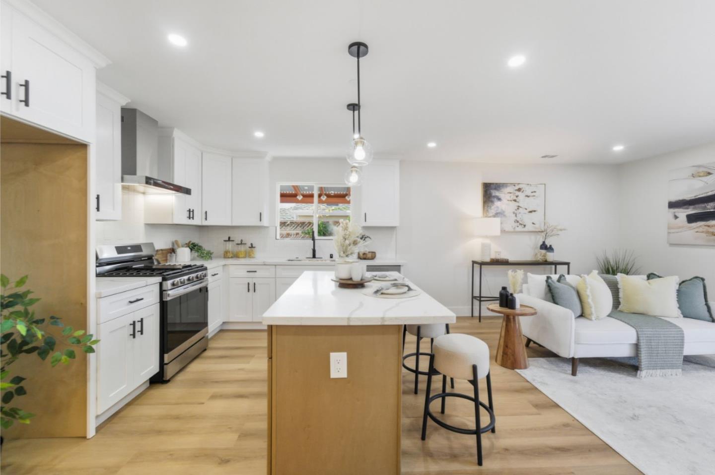 391 Gross Street Milpitas, CA 95035 - Photo 5 of 29 a large kitchen with kitchen island a large counter top space a sink stainless steel appliances and cabinets