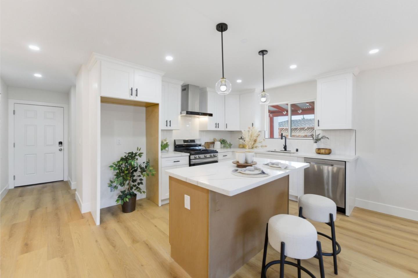 391 Gross Street Milpitas, CA 95035 - Photo 8 of 29 a kitchen that has a lot of cabinets in it with stainless steel appliances