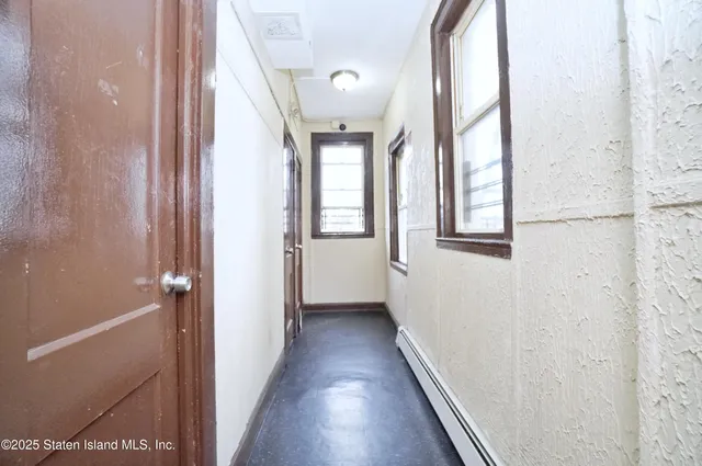 a view of a hallway with a window