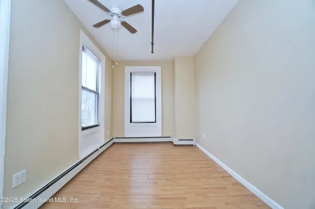 a view of room with hardwood floor and window
