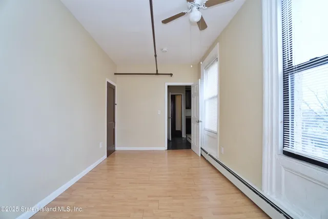 a view of hallway with stairs and wooden floor