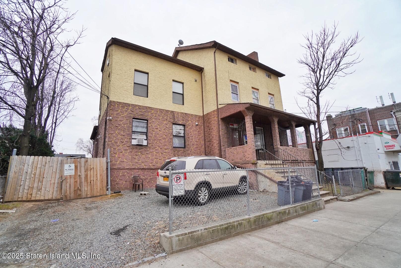 90 Vreeland Street Staten Island, NY 10302 - Photo 2 of 25 a car parked in front of a white house
