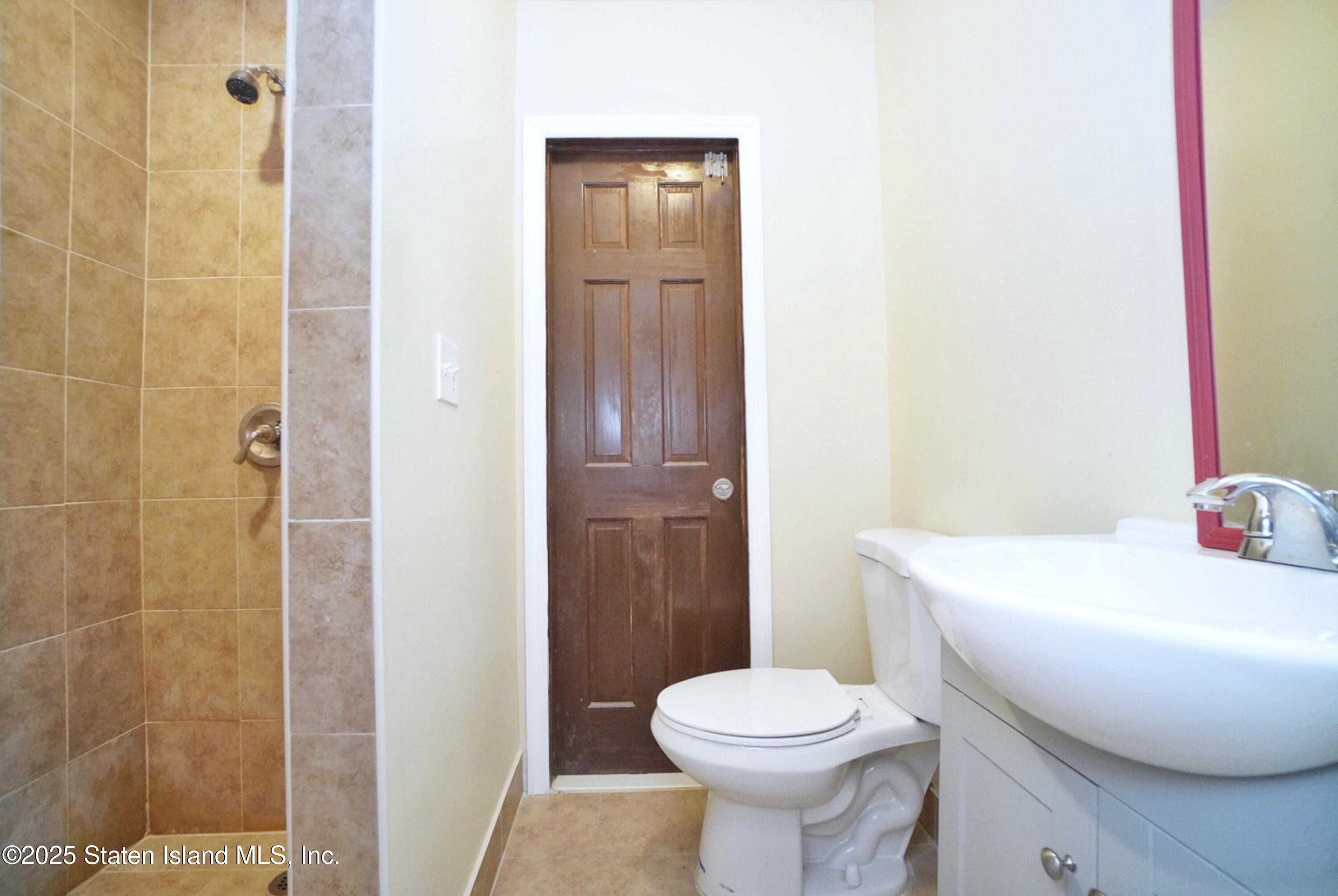 90 Vreeland Street Staten Island, NY 10302 - Photo 21 of 25 a white toilet sitting next to a bathroom sink