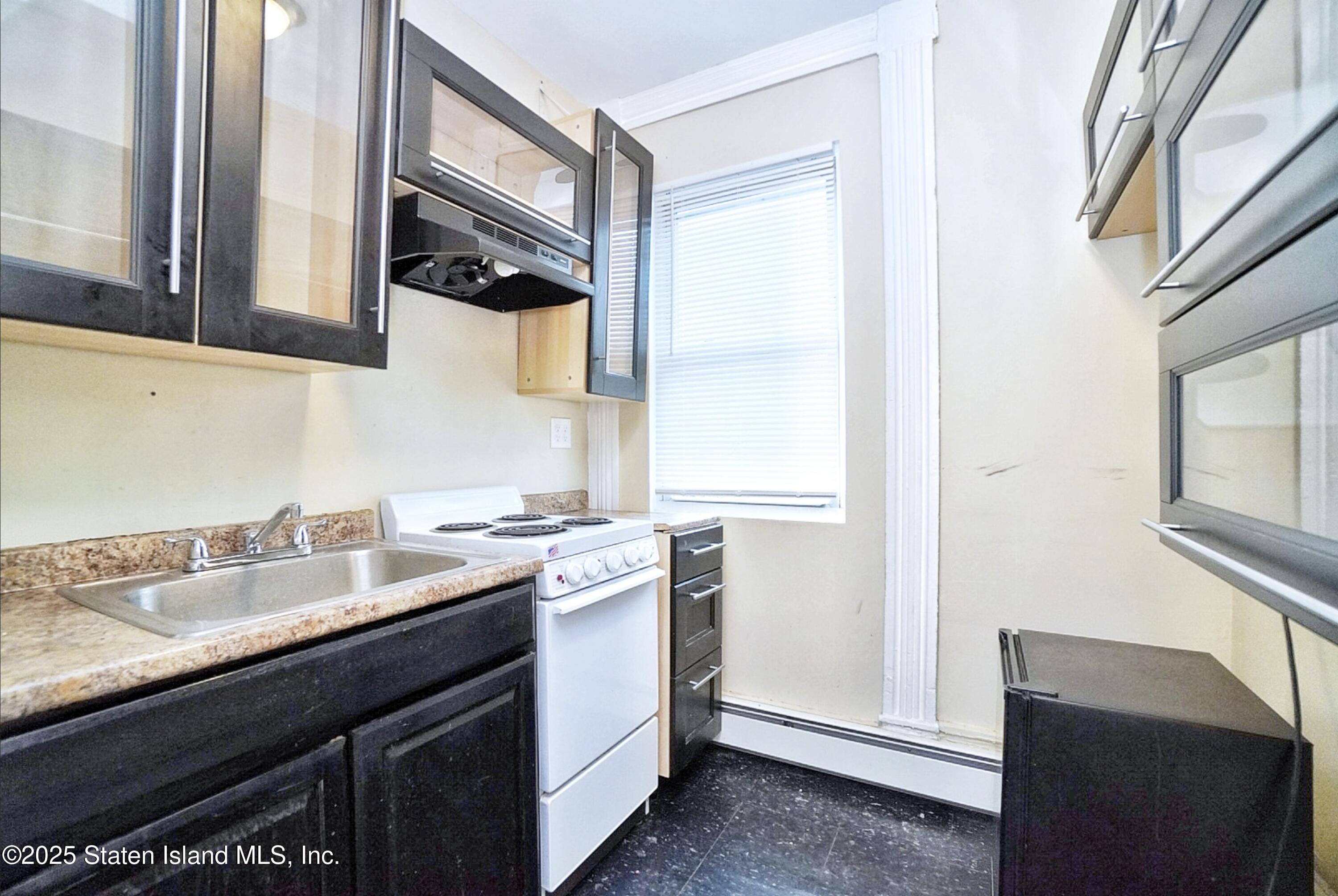 90 Vreeland Street Staten Island, NY 10302 - Photo 22 of 25 a kitchen with a sink cabinets appliances and a window