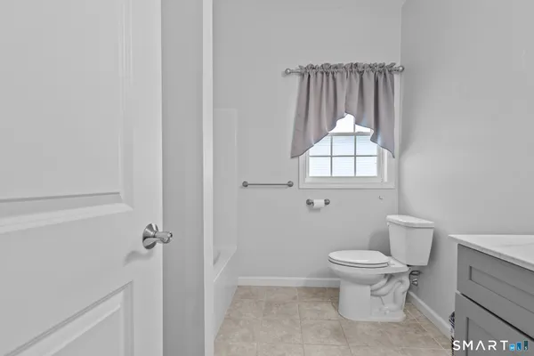 a white toilet sitting next to a bathroom sink