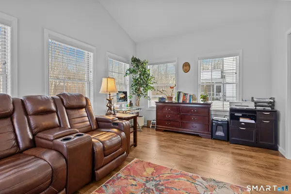 a living room with furniture and a dresser