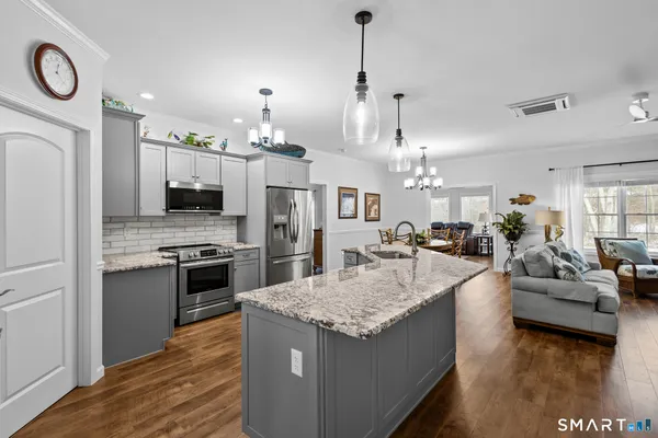 a large kitchen with sink cabinets and stainless steel appliances