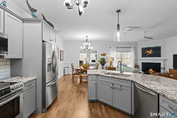a kitchen with stainless steel appliances granite countertop a stove refrigerator and cabinets