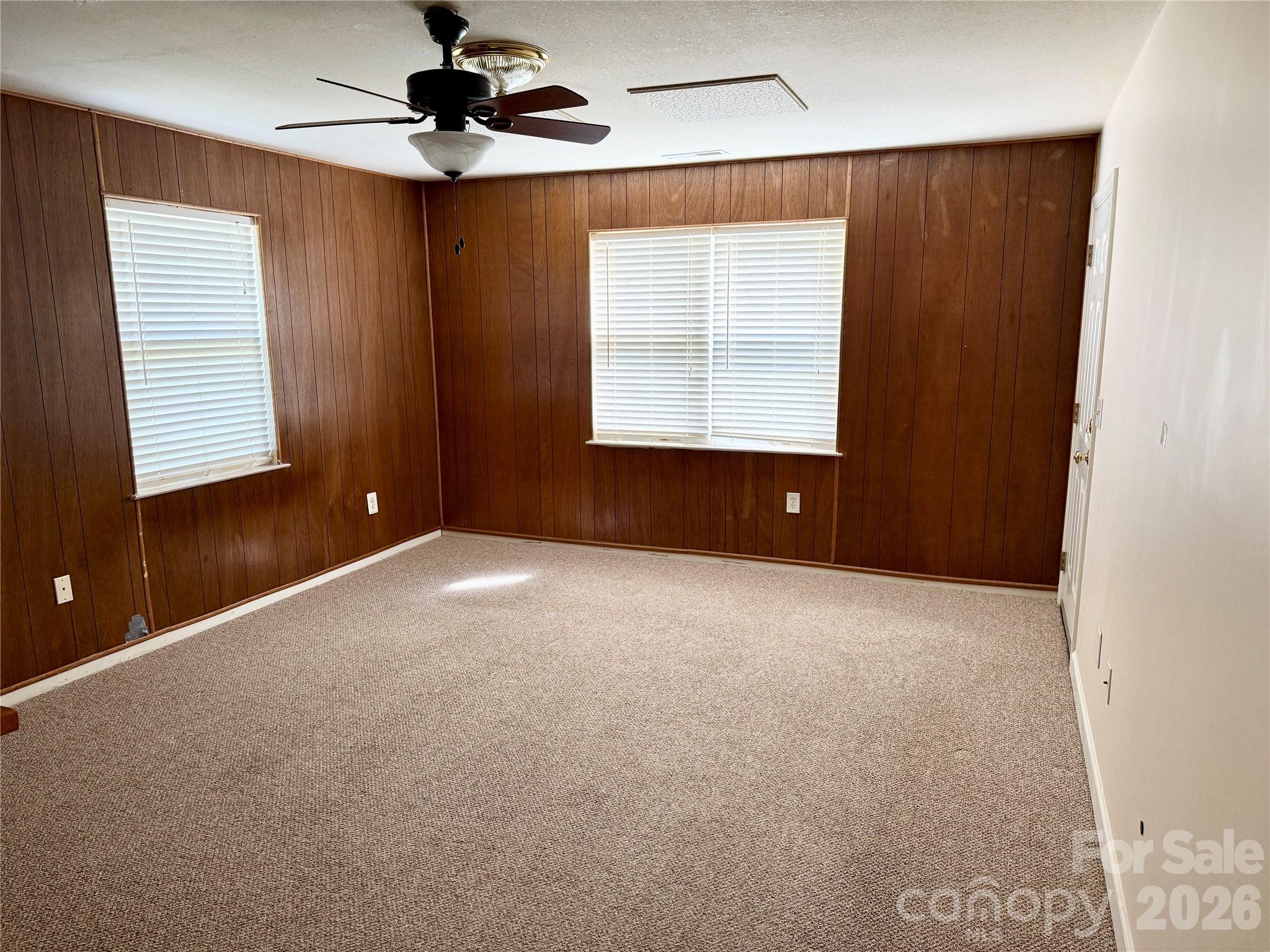 703 Olde Covington Way Arden, NC 28704 - Photo 11 of 23 an empty room with windows and fan