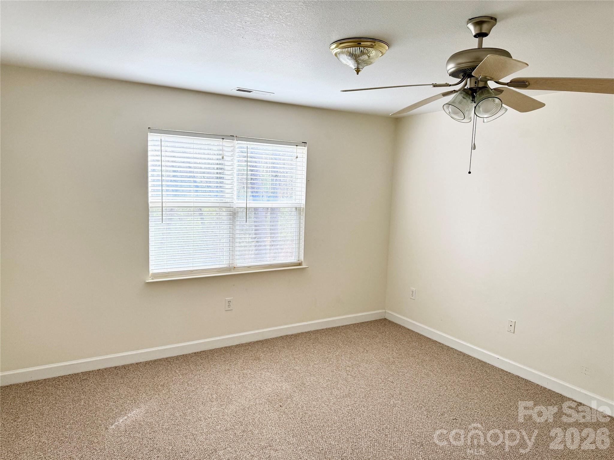 703 Olde Covington Way Arden, NC 28704 - Photo 12 of 23 an empty room with a window