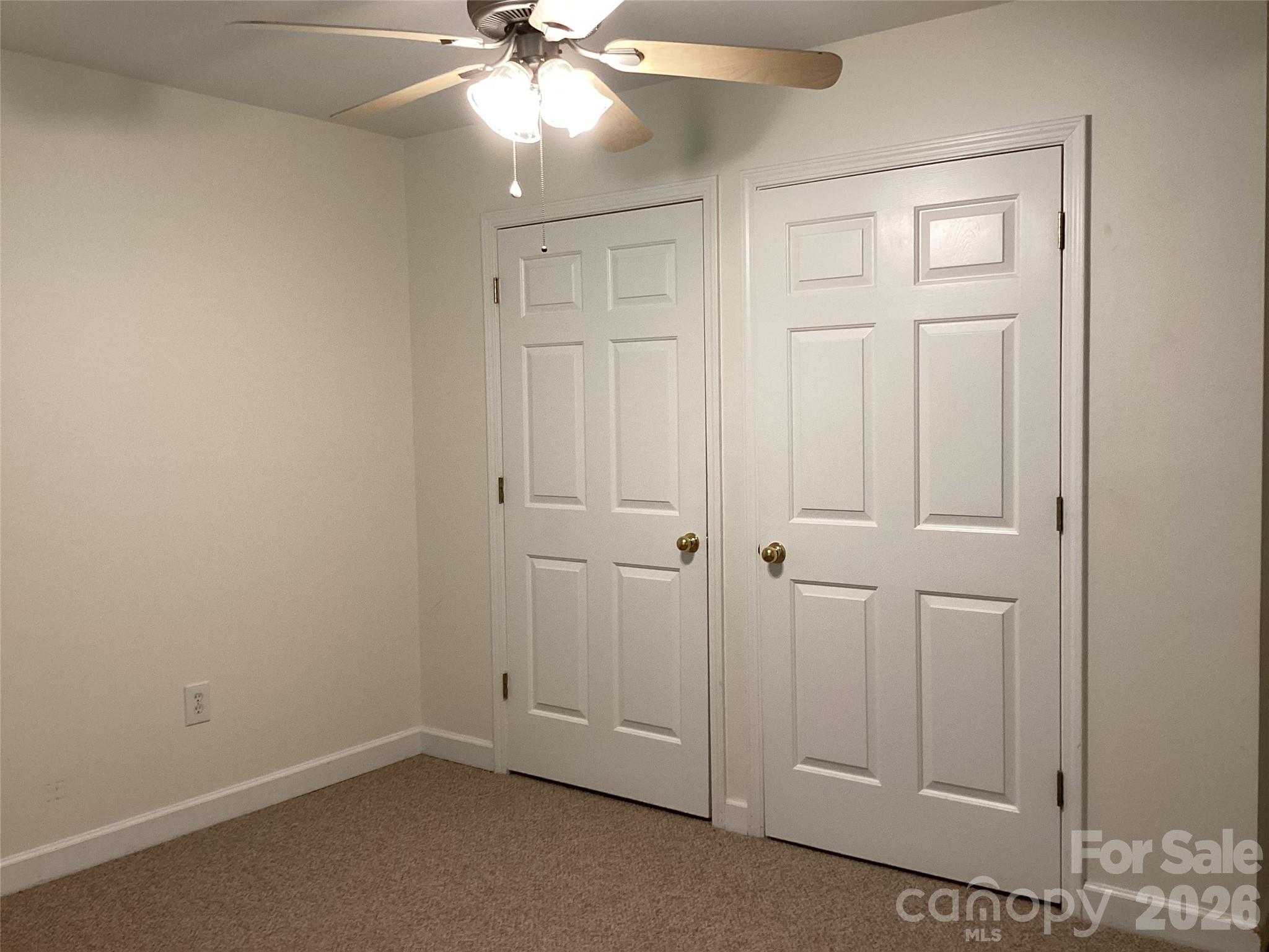 703 Olde Covington Way Arden, NC 28704 - Photo 15 of 23 an empty room with windows and fan