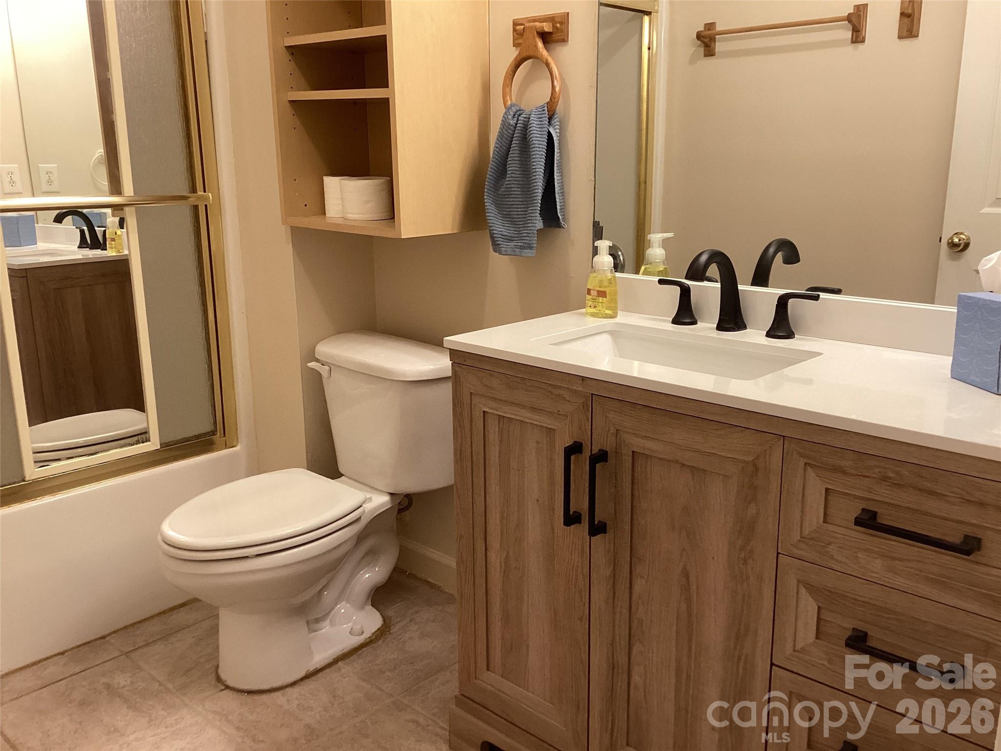 703 Olde Covington Way Arden, NC 28704 - Photo 17 of 23 a bathroom with a sink and a toilet