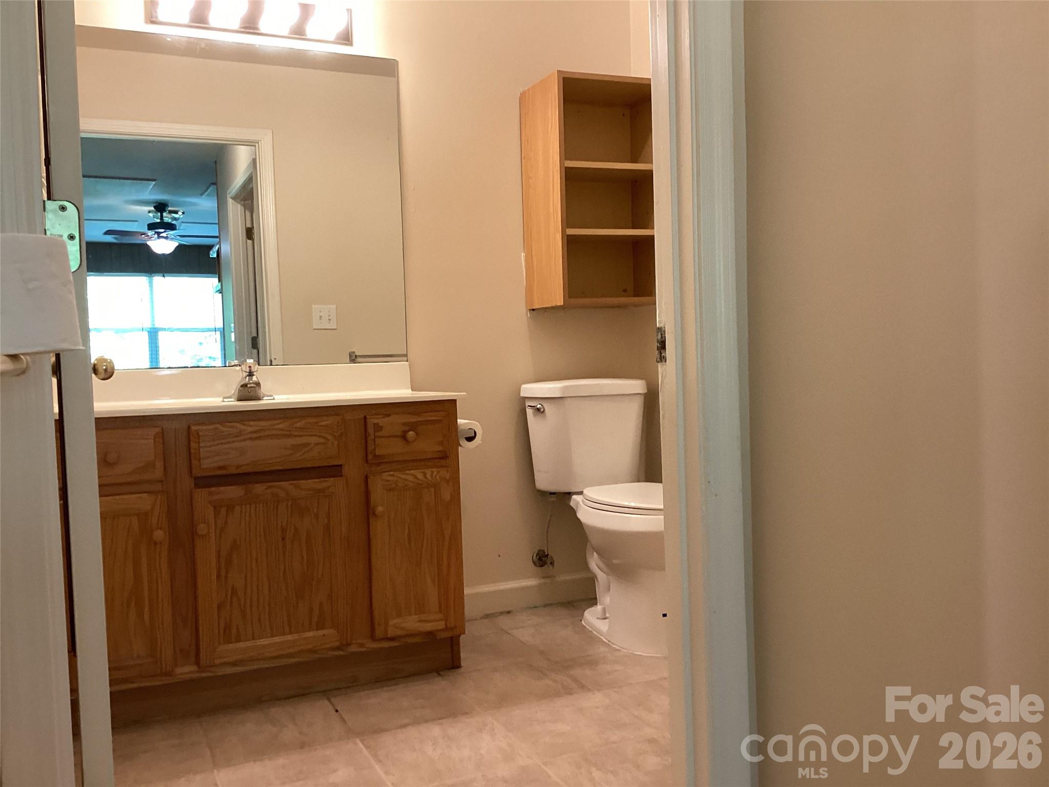 703 Olde Covington Way Arden, NC 28704 - Photo 18 of 23 a bathroom with a sink a toilet and mirror
