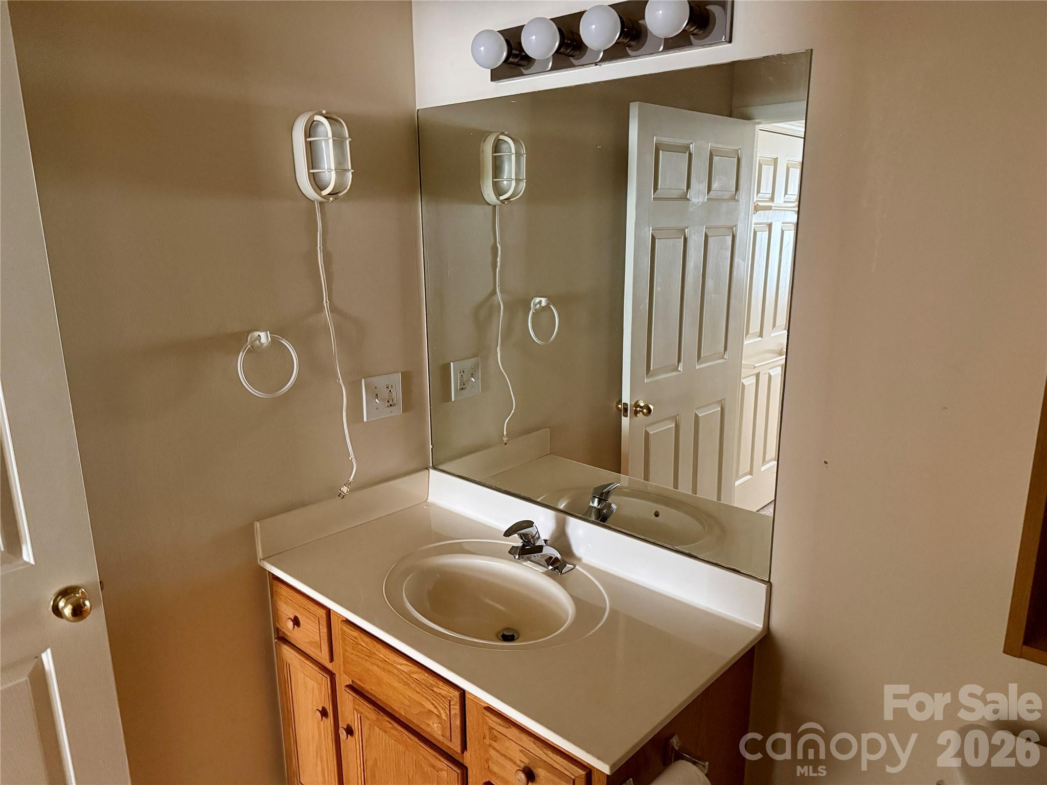 703 Olde Covington Way Arden, NC 28704 - Photo 21 of 23 a bathroom with a sink and mirror