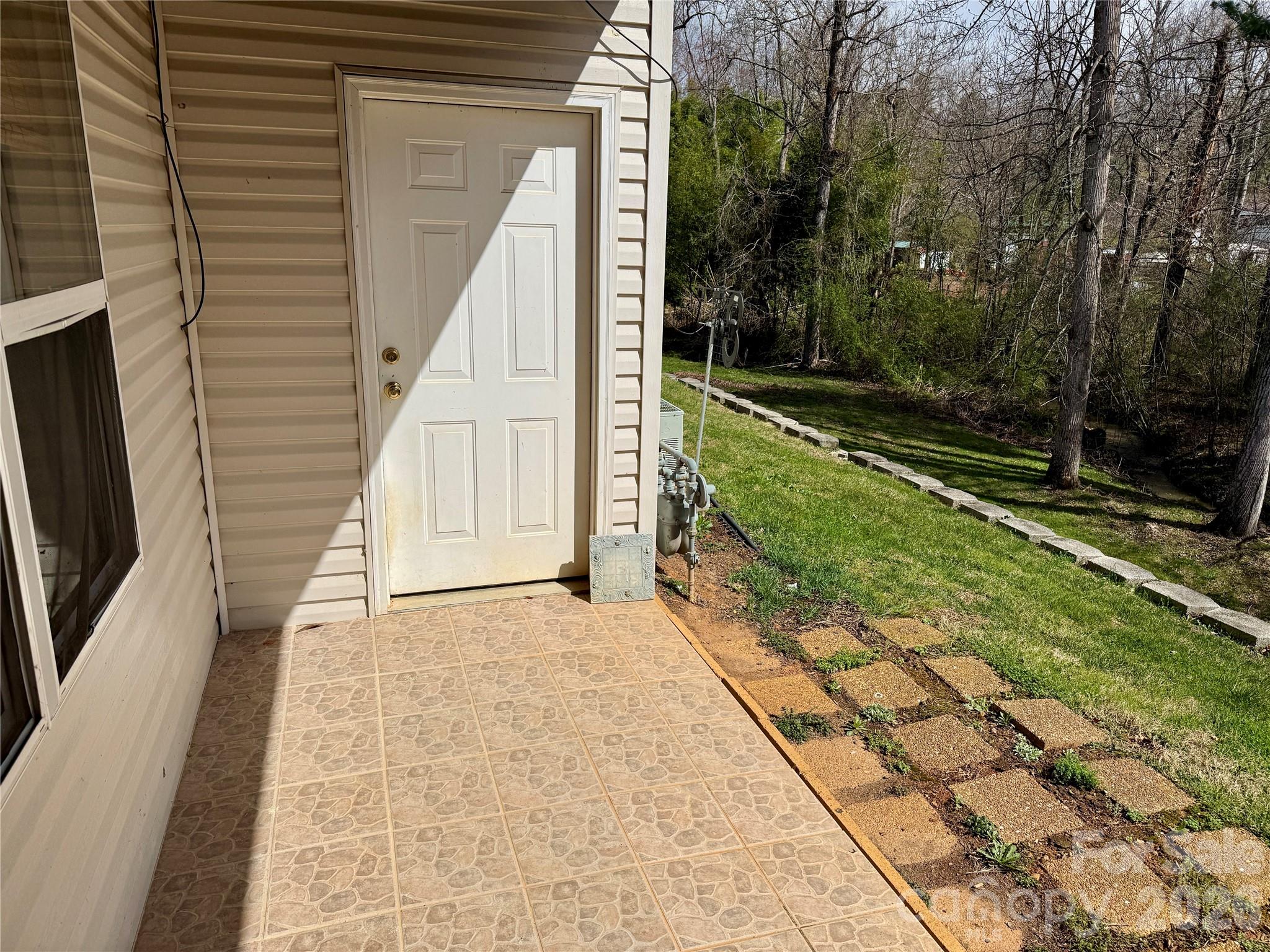 703 Olde Covington Way Arden, NC 28704 - Photo 22 of 23 a view of backyard with barbeque grill and stairs