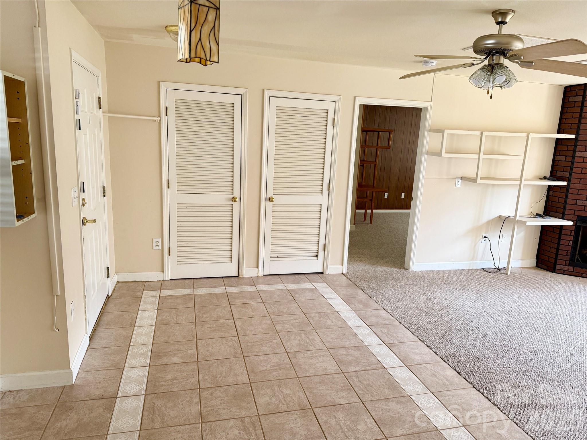 703 Olde Covington Way Arden, NC 28704 - Photo 7 of 23 a view of empty room with windows and a ceiling fan