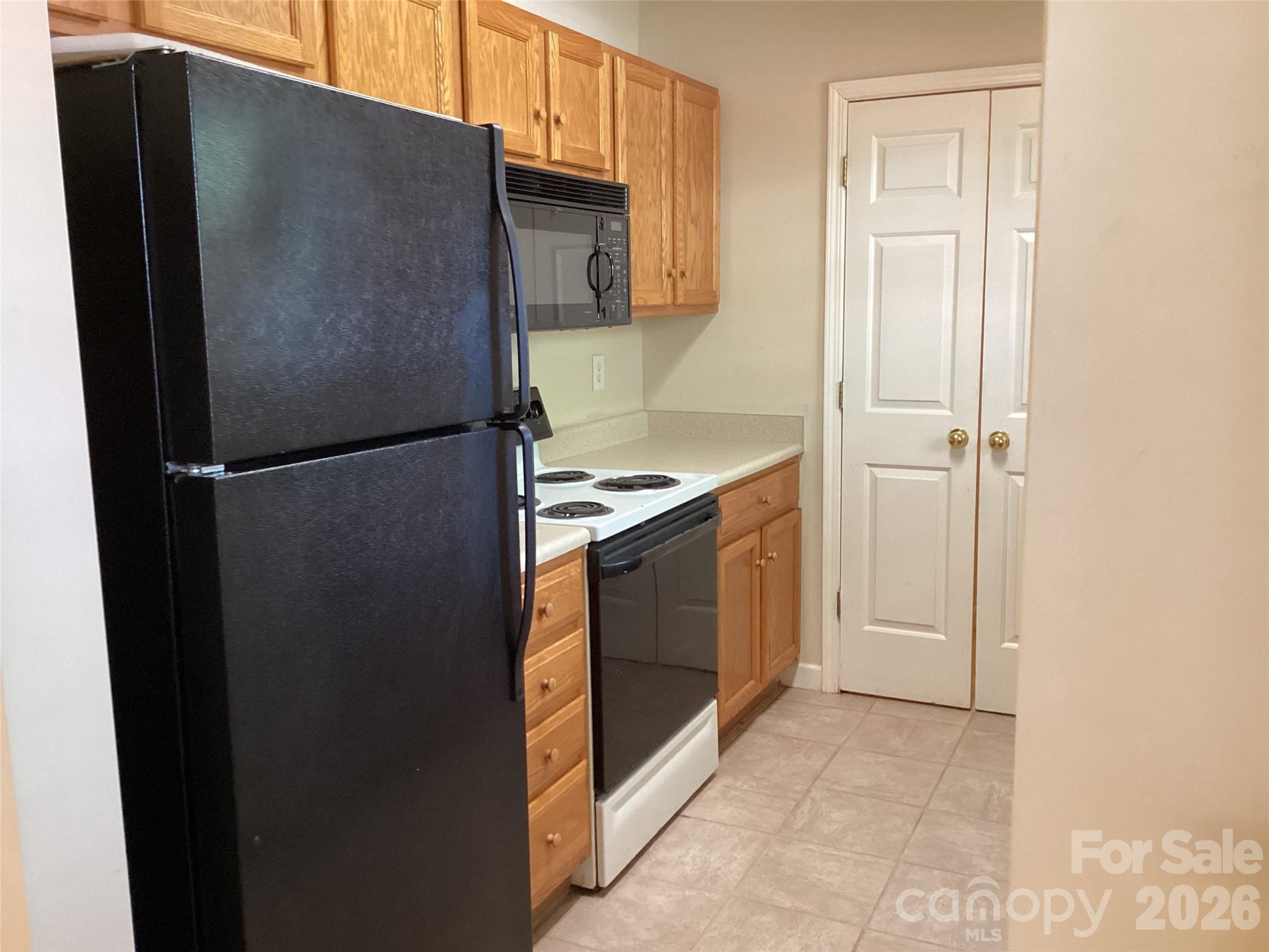 703 Olde Covington Way Arden, NC 28704 - Photo 8 of 23 a kitchen with a refrigerator and a stove