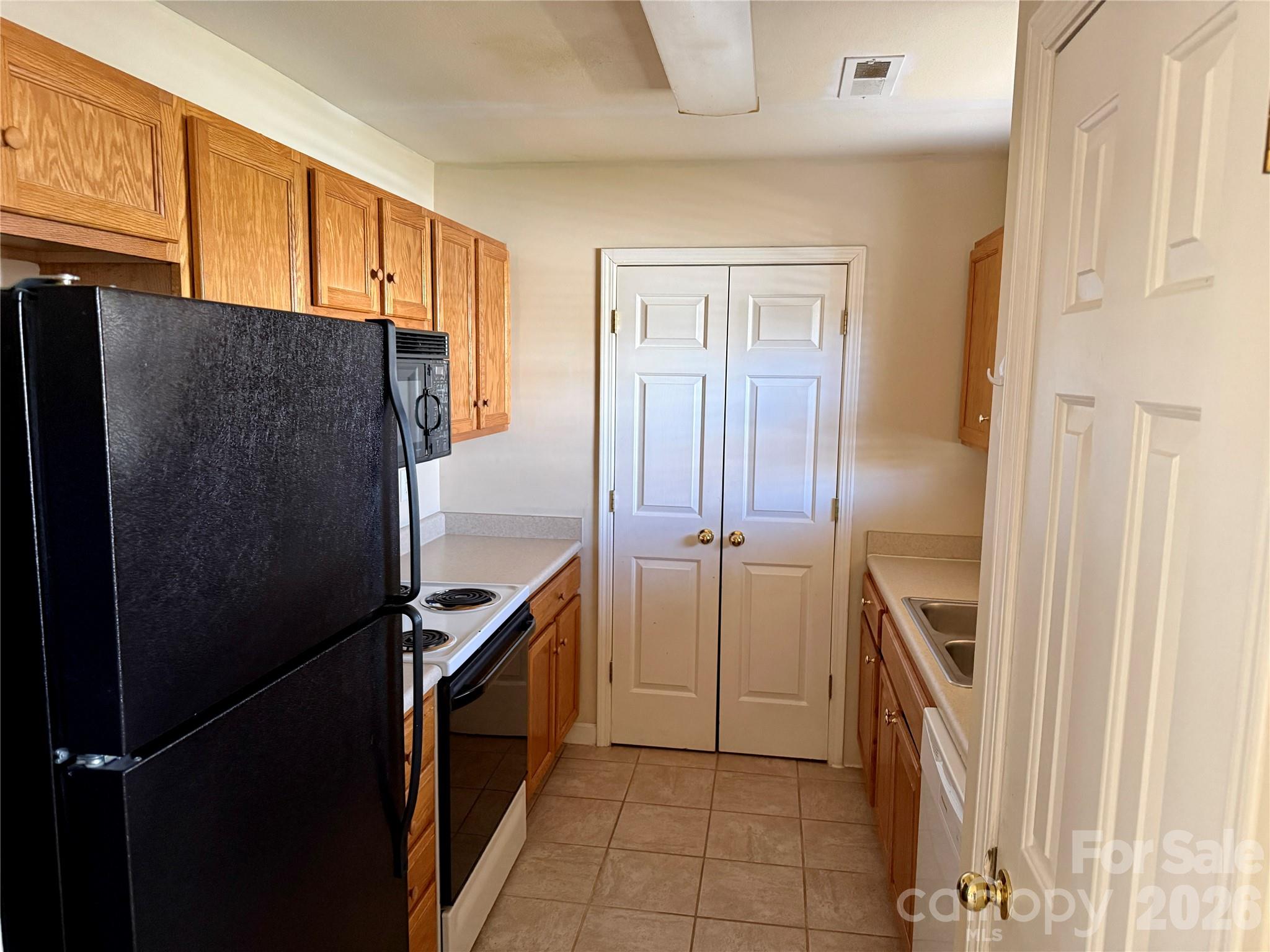 703 Olde Covington Way Arden, NC 28704 - Photo 9 of 23 a kitchen with stainless steel appliances granite countertop a refrigerator and a stove top oven